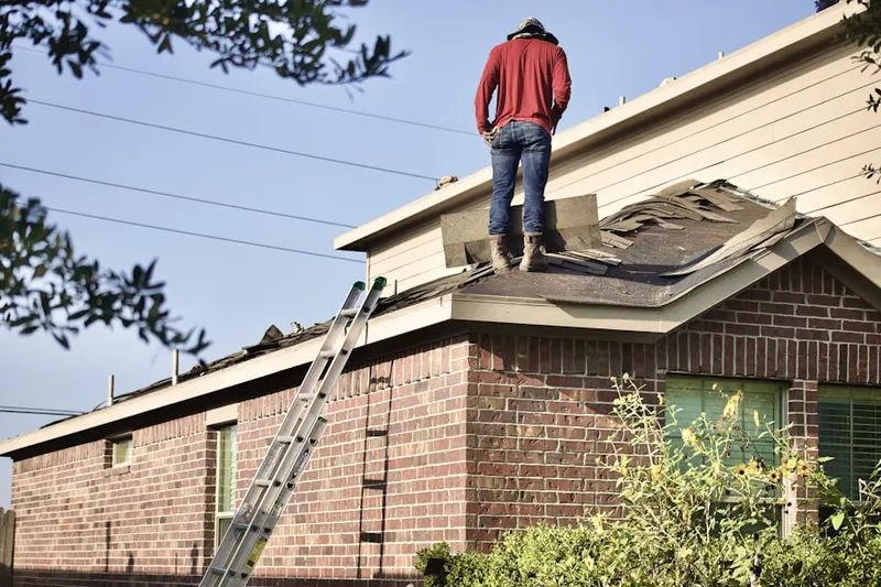 Professional roofer working on a residential roof in Rigby